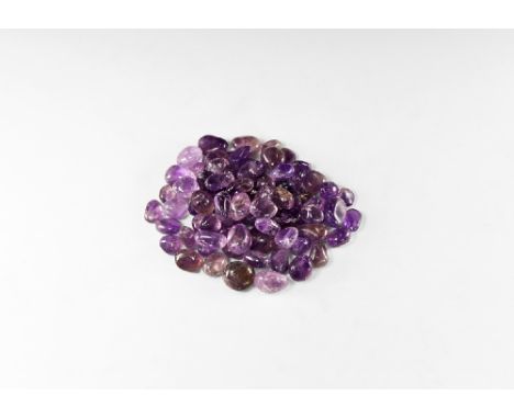 A group of seventy eight polished 'tumblestone' pebbles of amethyst ranging in colour from a pale, translucent purple, to a d