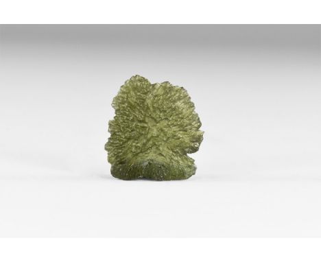 A piece of dark green, almost translucent moldavite; moldavite is melted material splashed out of the Nordlinger Ries meteor 