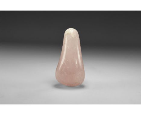 A large piece of polished teardrop-shaped rose quartz crystal with rainbow reflections. See Bonewitz, Dr. Ronald Louis, Rocks