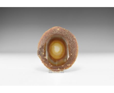 A large cut and polished agate slice with one surface dished to form a bowl with bands of red and cream. See Bonewitz, Dr. Ro