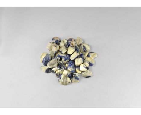A group of fifty sodalite 'tumblestone' pebbles with a deep blue colour in a white matrix. See Bonewitz, Dr. Ronald Louis, Ro