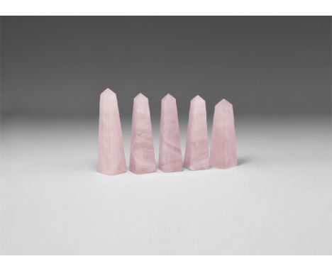 A group of five cut and polished rose quartz obelisks of a pale pink colour. See Bonewitz, Dr. Ronald Louis, Rocks & Minerals