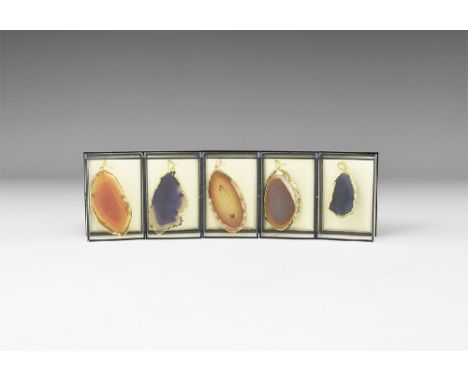 A group of five cut and polished agate pendant slices ranging in colour from blue, purple, orange and brown, with electroform