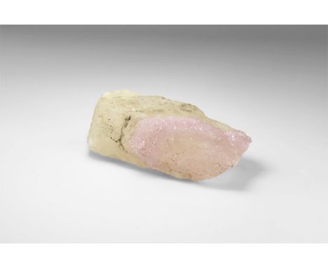 A specimen with a band of hundreds of rose quartz crystals across a base of colourless quartz crystal, from Brazil, in old wh