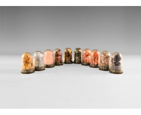 Group comprising: ten acrylic display domes, each filled with a quantity of polished specimens of a single mineral, with agat