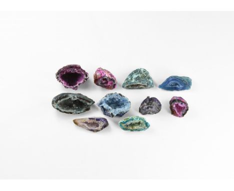 A group of ten cut and polished agate geodes of varying colours and with clusters of crystals in the central cavities; colour