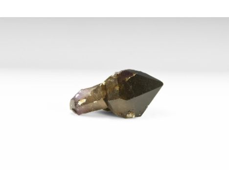 A very large amethyst crystal with dark purple colouring, well formed prism facets and smaller white crystals to the base. Se