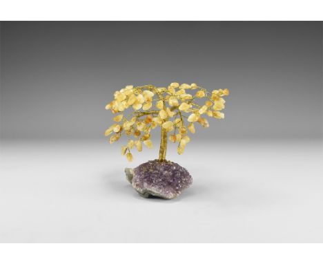 A medium size gemstone tree consisting of a brass trunk and branches tipped with polished citrines, mounted on a section of a