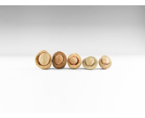 Group of five wind-rounded pebbles with their individual hollowed out 'nests', from the Kalahari Desert region, western Afric