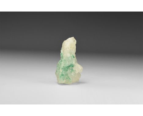 A large piece of quartz with many emerald crystals within the matrix, in white card tray with label reading: 'EMERALD IN QUAR