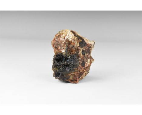 A rare specimen of cuprite from Cornwall, consisting of cubic crystals on a rock groundmass, in old white card tray with hand
