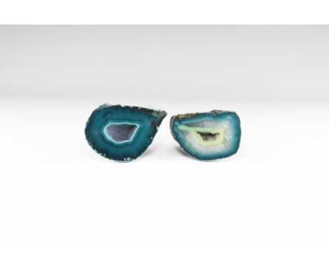 Two cut and polished agate geode halves with bands of blue to the edges, honeycomb matrix to the body and with cavity in the 