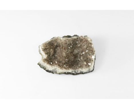 A mass of pale purple amethyst crystals with flecks of darker crystals, on a sheet of layered blue-grey and white agate. See 