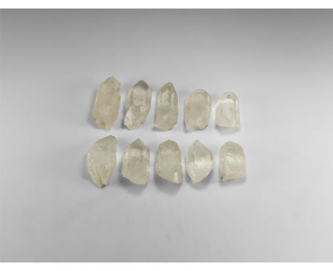 A group of 10 hexagonal prism quartz points of a pure and clear colour, well formed facets; some with smaller points at the b