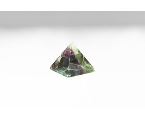 A cut and polished pyramid of fluorite displaying green and purple crystal colour and with rainbow reflections. See Bonewitz,