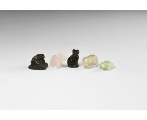 A group of carved gemstone animals including; rose quartz elephant, labradorite cat, serpentine tortoise, quartz pig, obsidia