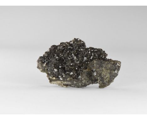 An extremely fine group of lustrous cassiterite crystals on a groundmass of massive cassiterite, with accessory quartz, from 