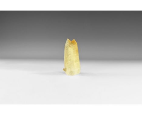 A large double needle-shaped crystal of yellow calcite from the historic Miller Collection with the colour darkening towards 