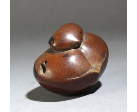 A mid 19th century Japanese netsuke from Meiji period. Signed Gyokko. In carved wood portraying two chestnuts, one over the o