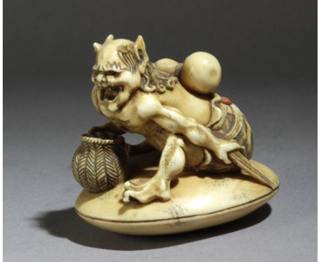 A late 19th century Japanese netsuke from Meiji period. Signed Tomochika. In carved elephant ivory and coralportraying 'Oni N