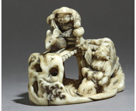 A mid 19th century Japanese netsuke from Meiji period. Signed Ryomin. In carved elephant ivory portraying a group of characte