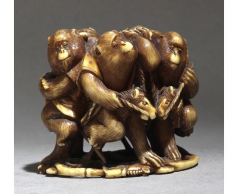 A late 19th century Japanese netsuke from Meiji period. Signed Masatomo on the base. In carved ivory portraying a group of fi