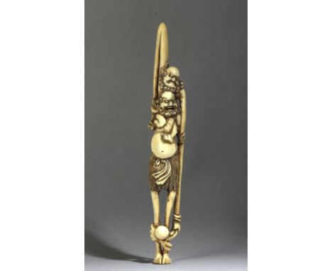 A Japanese netsuke-sashi circa 1800 from Edo period. Not signed. In carved elephant ivory portraying a standing 'Ashinaga and