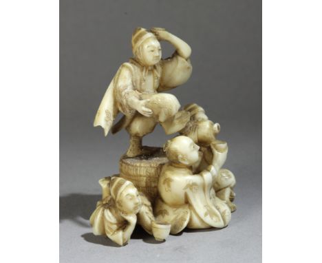 A 19th century Japanese netsuke okimono from Meiji period. Signed Minzan. In carved elephant ivory portraying a group of four