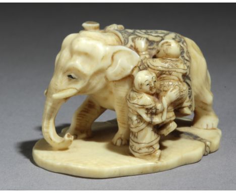 A late 19th century Japanese netsuke from Meiji period. Signed Shukko. In carved elephant ivory portraying a group of three c