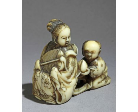 A mid 19th century Japanese netsuke from Edo period. Not signed. In carved elephant ivory portraying a 'Karako' offering a pe