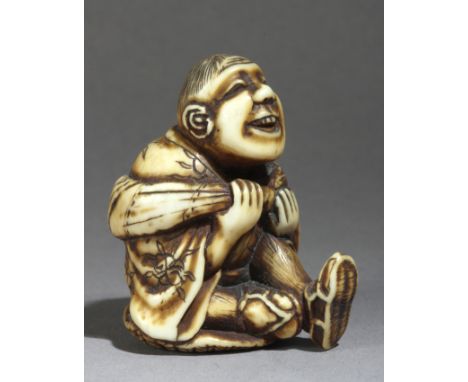 A mid 19th century netsuke from Meiji period. Not signed. In carved elephant ivory portraying a man sat over his hat ans wear