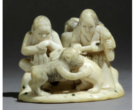 A Japanese netsuke-okimono circa 1860-1880 from Meiji period. Signed Ono Kiyomitsu. In carved elephant ivory portraying a gro