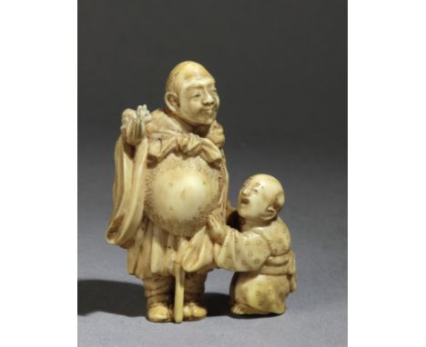 A 19th century Japanese netsuke in carved elephant ivory portraying a 'Karako' &nbsp;looking at his grandfather,who is holdin