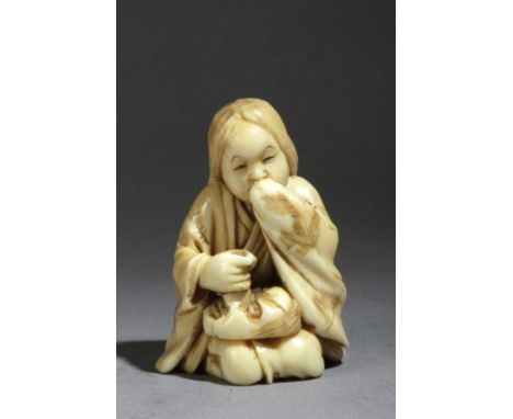 A Japanese netsuke circa 1860-1875 from Meiji period. Signed Sozan. In carved elephant ivory portraying a sat 'Okame' touchin