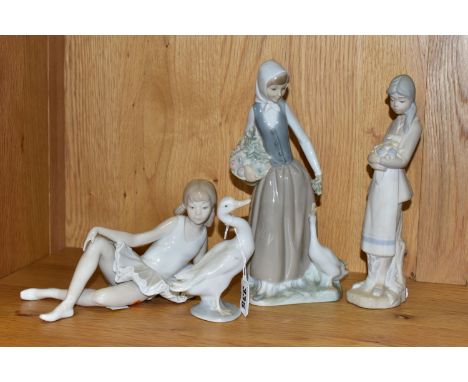 THREE FIGURINES INCLUDING NAO, AND A LLADRO DUCK, comprising Nao 'Reclining Ballerina' and 'Girl Feeding Goose' (hairline at 