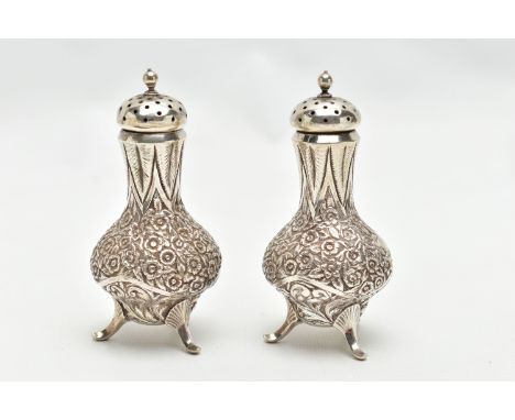 A PAIR OF WHITE METAL PEPPERETTES, baluster form, decorated with a floral and foliate pattern, engraved monograms, each with 