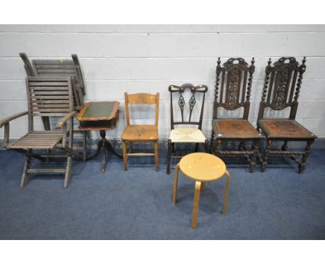 A PAIR OF 19TH CENTURY CARVED OAK HALL CHAIRS, with leather seat pads, an Arts and Crafts rush seat chair, an elm child's cha