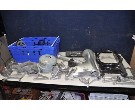 A TRAY CONTAINING MOTORCYCLE PARTS branded BMW, Aprilla, Nissin etc, including a swing Arm, peg holders, rear sprockets, fron
