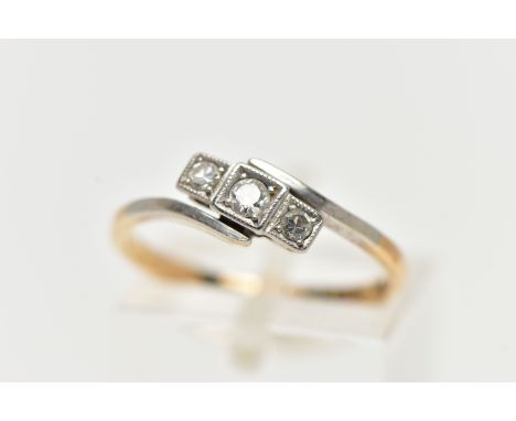 A THREE STONE DIAMOND RING, a central round brilliant cut with two single cut diamonds either side, set within a twisted whit