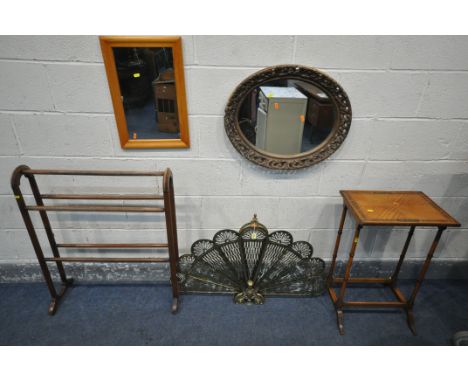 A BRASS PEACOCK FAN FIRESCREEN, a single satinwood Quartetto table, a beech towel rail, a circular foliate wall mirror, and t