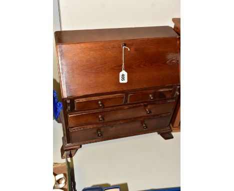 A MINIATURE BUREAU, with stained finish, pull down front revealing internal drawers and compartments, four outer drawers and 