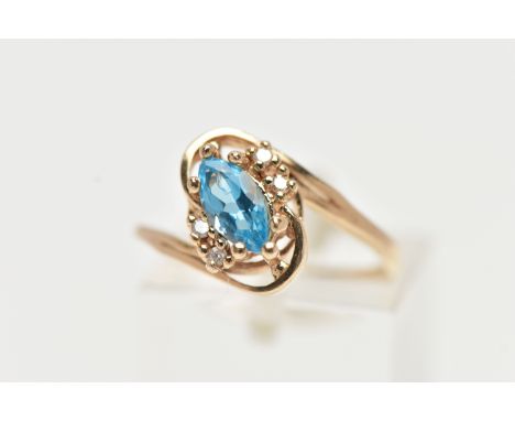 A TOPAZ AND DIAMOND DRESS RING, a marquise cut topaz accented with four round brilliant diamonds, set upon a twisted yellow m