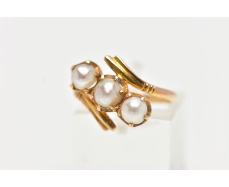 A CULTURED PEARL RING, three cultured white pearls with a silver hue, prong set in a twisted mount design, set in yellow meta