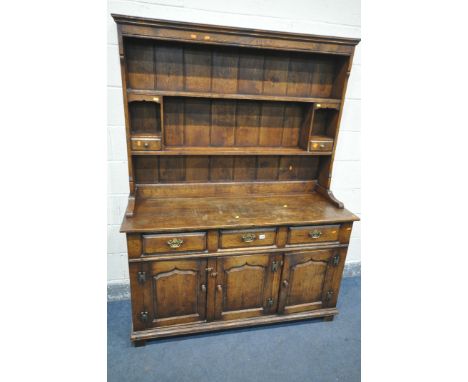 A REPRODUCTION GEORGIAN STYLE OAK DRESSER, with a top that has an arrangement of shelves, over a base with three drawers, and