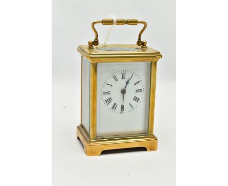 A BRASS CARRIAGE CLOCK, rectangular form, white dial, Roman numerals, four glass viewing panels to the sides, rear and top, a