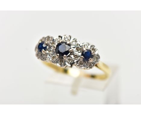 A SAPPHIRE AND DIAMOND RING, three circular cut blue sapphires, set with a surround of single cut diamonds in a scalloped whi