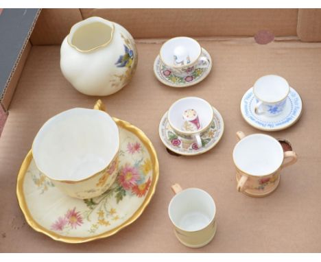 Royal Worcester cup and saucer decorated with spring flowers on a blush ivory ground with gilt borders, Royal Worcester minia