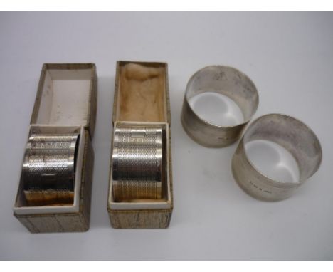Pair of Geo.VI hallmarked engine turned silver napkin rings, Birmingham 1928, boxed and a similar pair, London 1944, 3.8oz (4