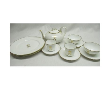 Early C20th French porcelain tea service, decorated with crowned N in gilt with gilt line borders, teapot with printed marks 