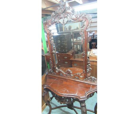 Chippendale style console mirror with pierced scrolled cresting and a matching serpentine front console table on angular cabr